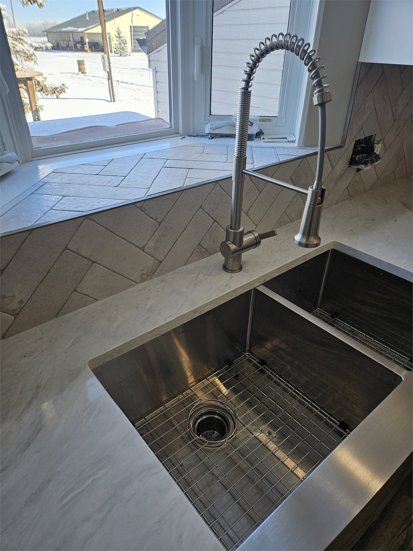 Herringbone kitchen backsplash with continuous grout lines around wrapped corners, detail view 2