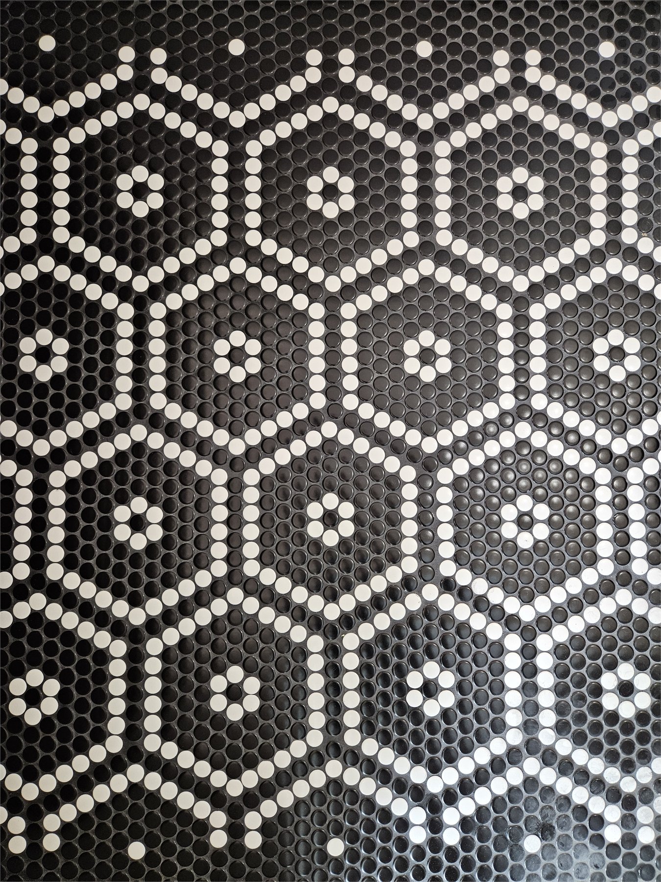 Custom black and white penny tile floor assembled in a hand-built pattern, detail view 3
